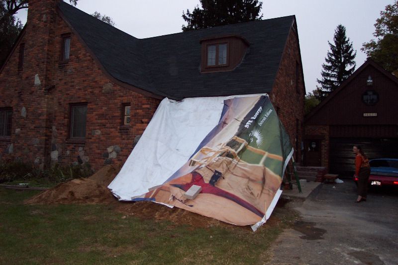 Construction after the first day ends with a tarp.