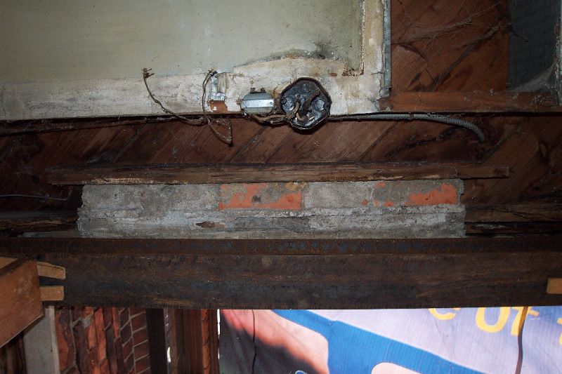 This straight-up view shows the concrete and bricks directly under the threshold of the door.