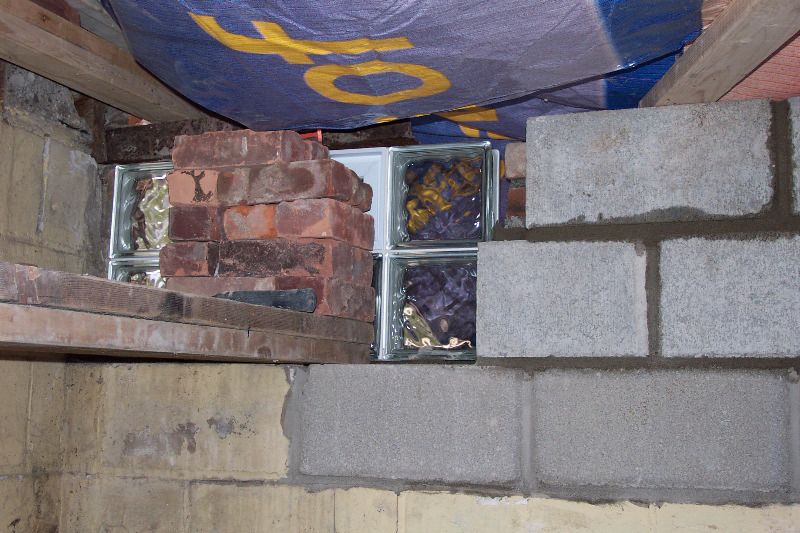 Behind the brickws is a new vented glass-block window.